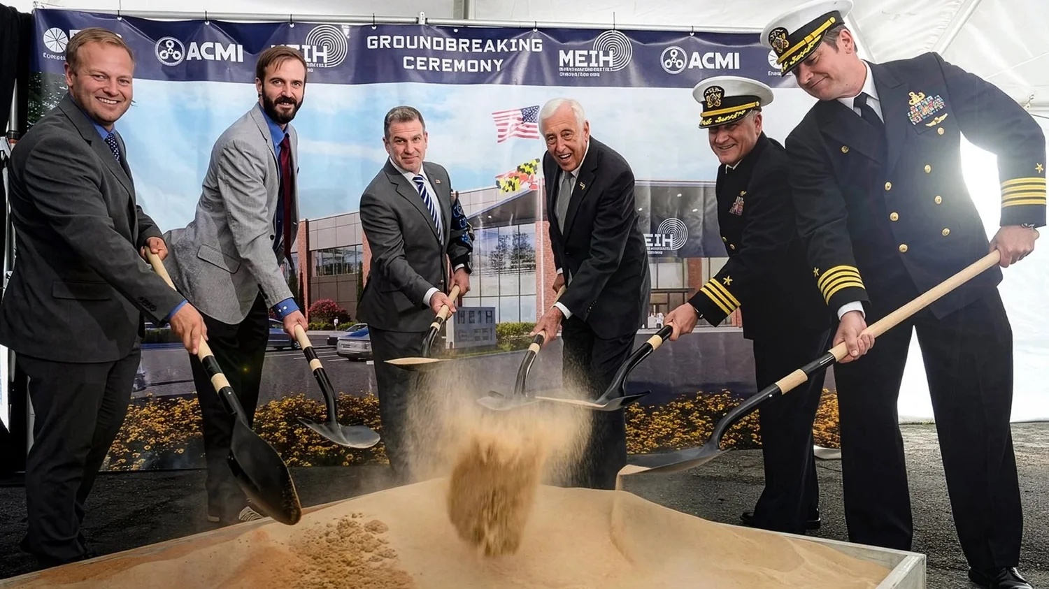 Officials turn the first shovels of dirt at the Maryland Energetics Innovation Hub groundbreaking ceremony